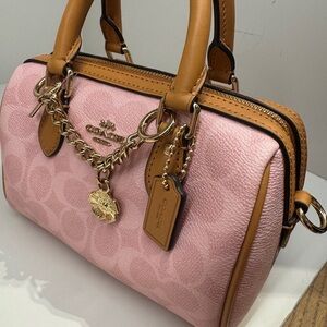 Coach Powder Pink Mini Rowan Crossbody Bag
In Signature Canvas With Charms